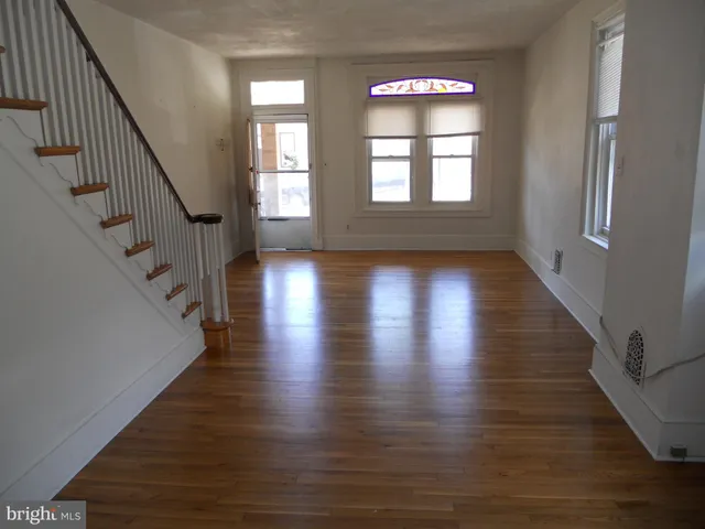 a view of an entryway with wooden floor and stairs