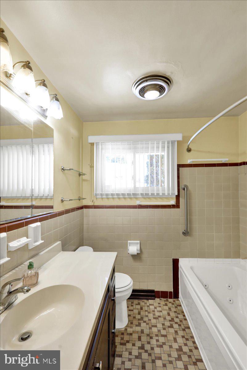 629 Lawrence Avenue Reading, PA 19609 - Photo 12 of 39 a bathroom with a sink a toilet a tub and a window
