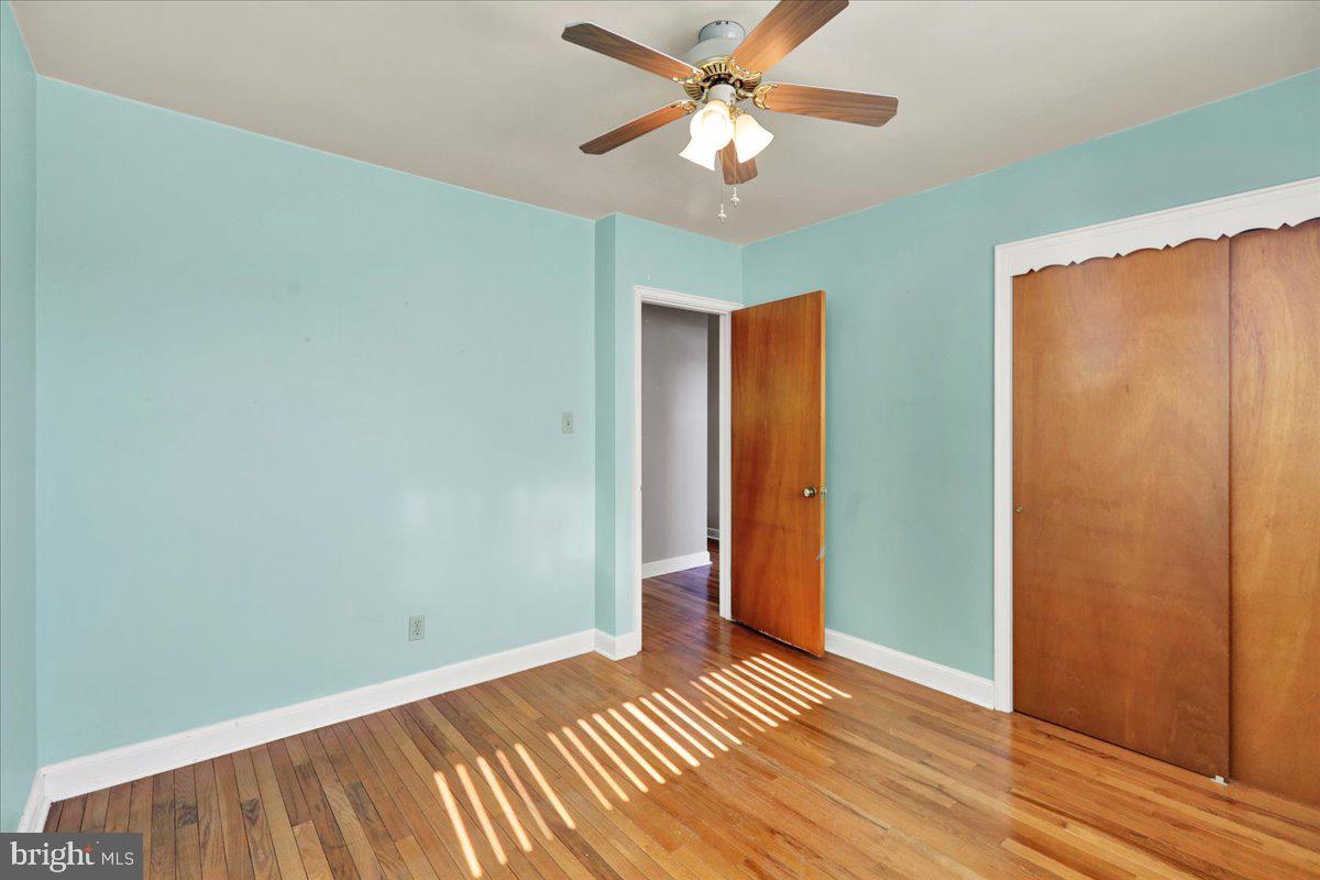 629 Lawrence Avenue Reading, PA 19609 - Photo 16 of 39 an empty room with wooden floor closet fan and windows