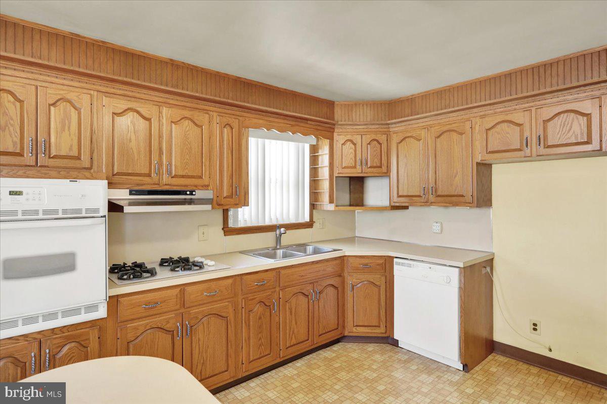 629 Lawrence Avenue Reading, PA 19609 - Photo 7 of 39 a kitchen with stainless steel appliances granite countertop a stove a sink and white cabinets