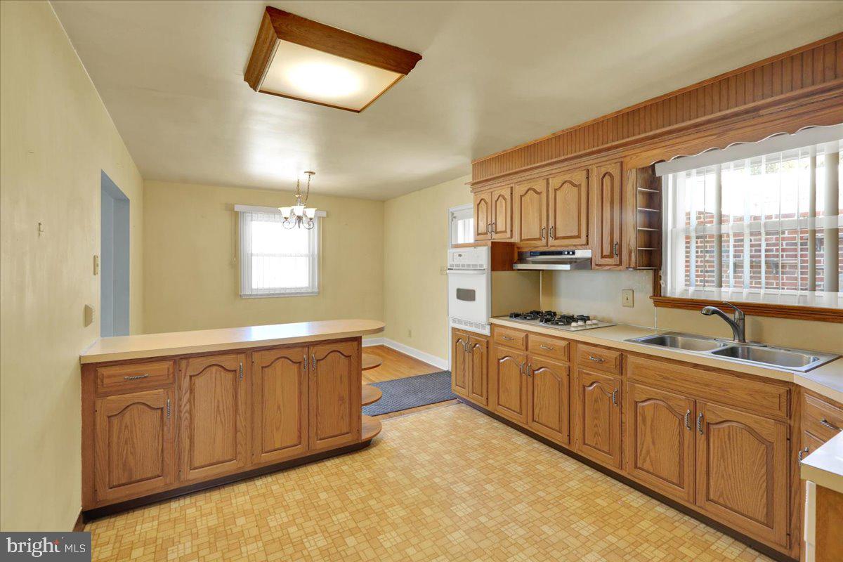 629 Lawrence Avenue Reading, PA 19609 - Photo 10 of 39 a large kitchen with kitchen island granite countertop a sink and white cabinets