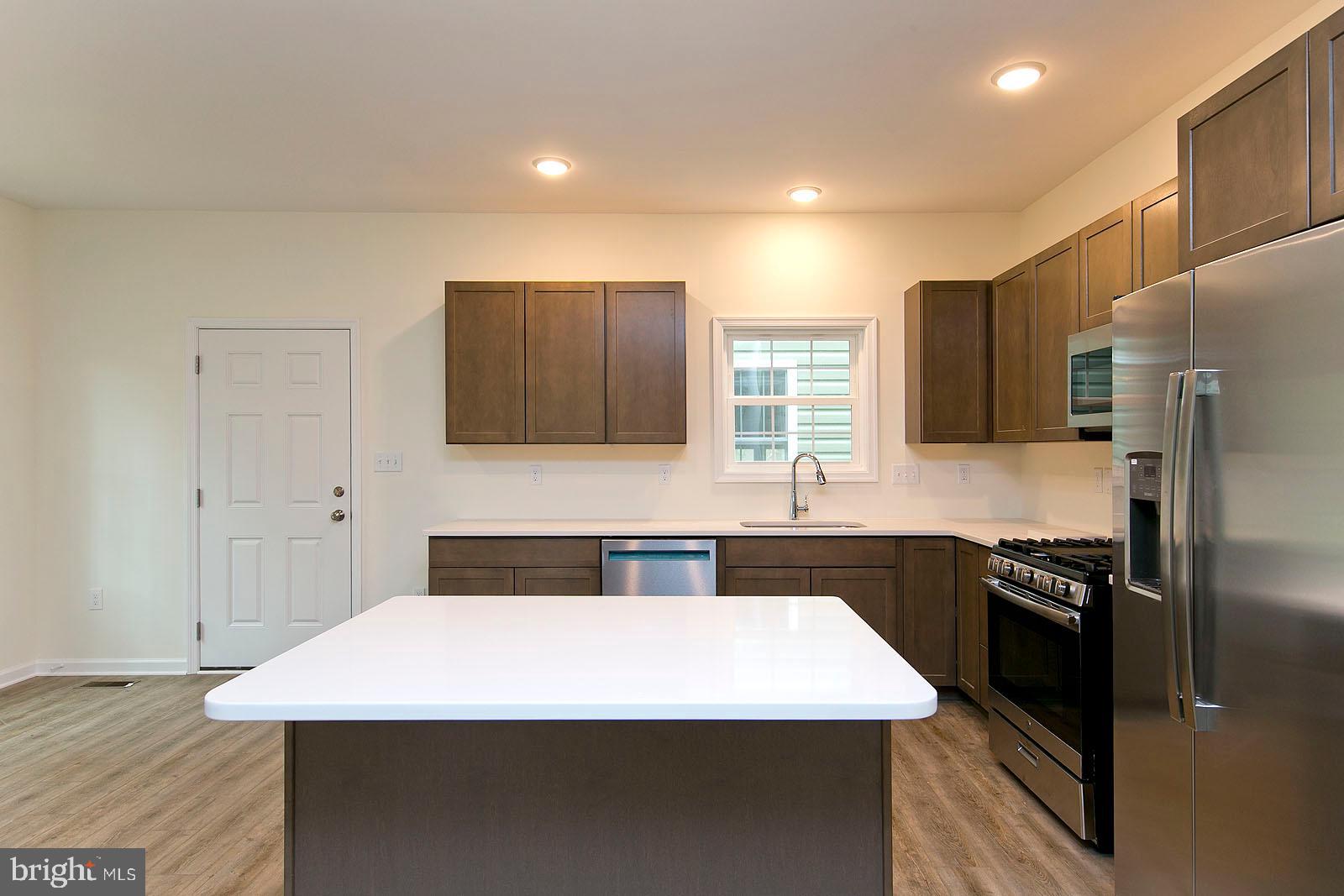 320 Pine Grove Road Bluemont, VA 20135 - Photo 11 of 28 a kitchen with a sink a stove top oven and refrigerator