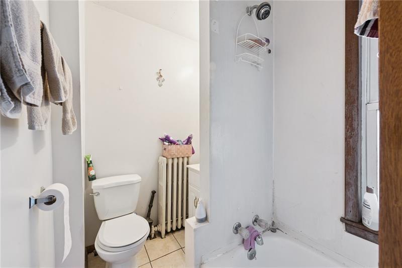 322 North 4th Street Apollo, PA 15613 - Photo 10 of 11 a white toilet sitting next to a bathroom sink