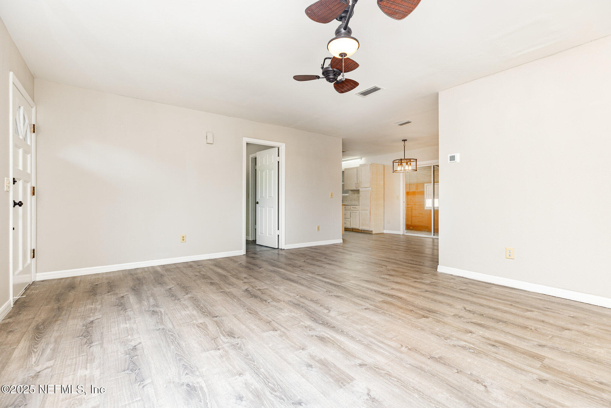 4341 Chokeberry Road Middleburg, FL 32068 - Photo 11 of 38 a view of a room with a ceiling fan and wooden floor