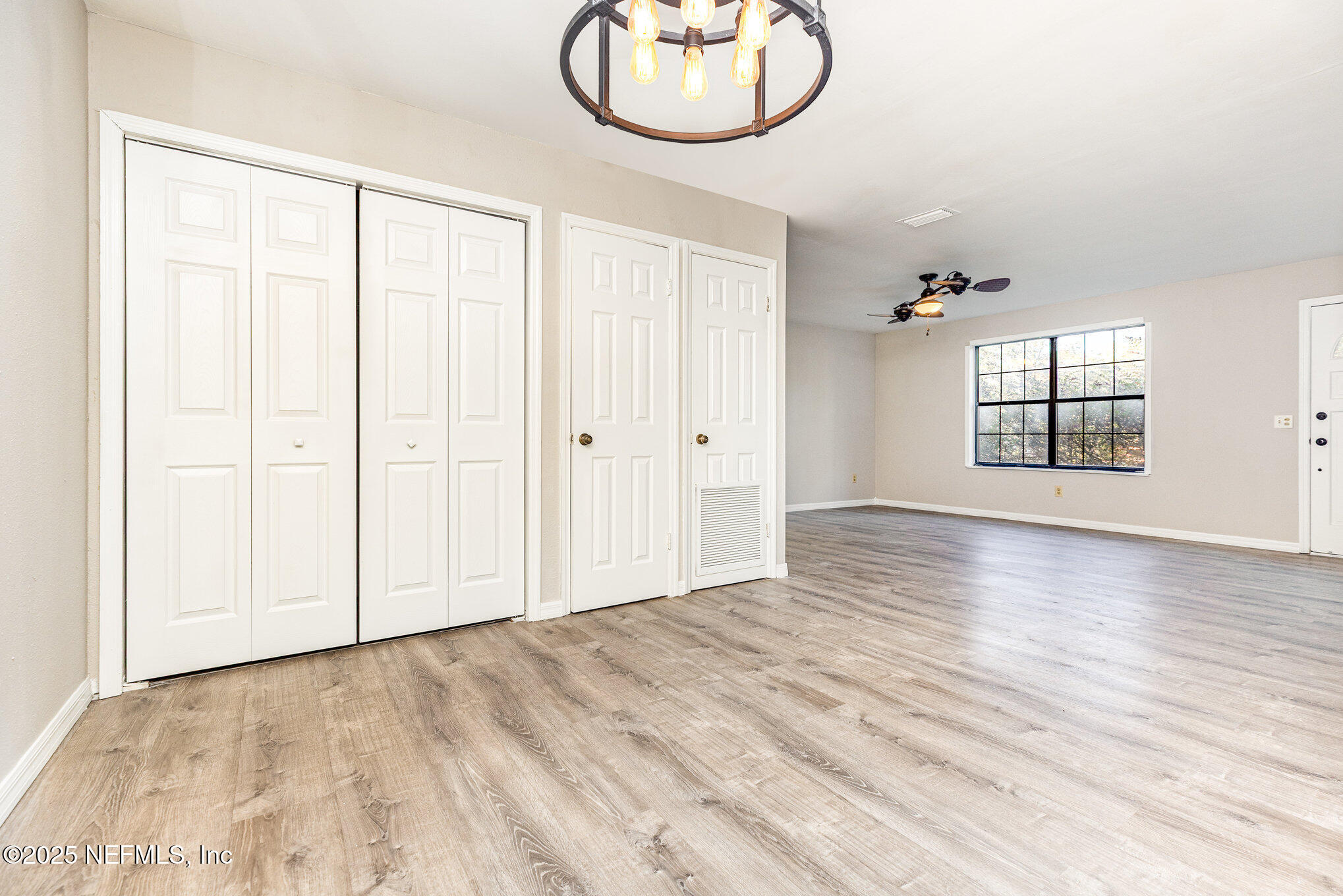 4341 Chokeberry Road Middleburg, FL 32068 - Photo 12 of 38 an empty room with wooden floor and windows