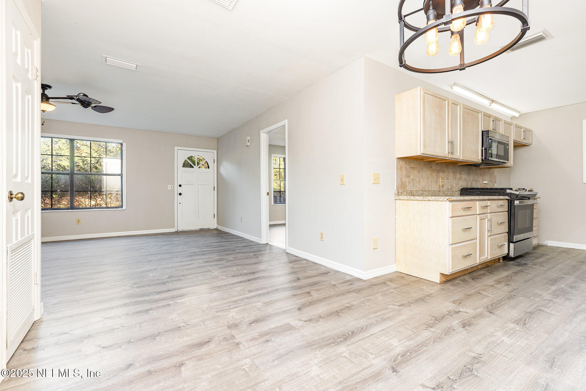 4341 Chokeberry Road Middleburg, FL 32068 - Photo 13 of 38 a view of a kitchen with furniture and a window