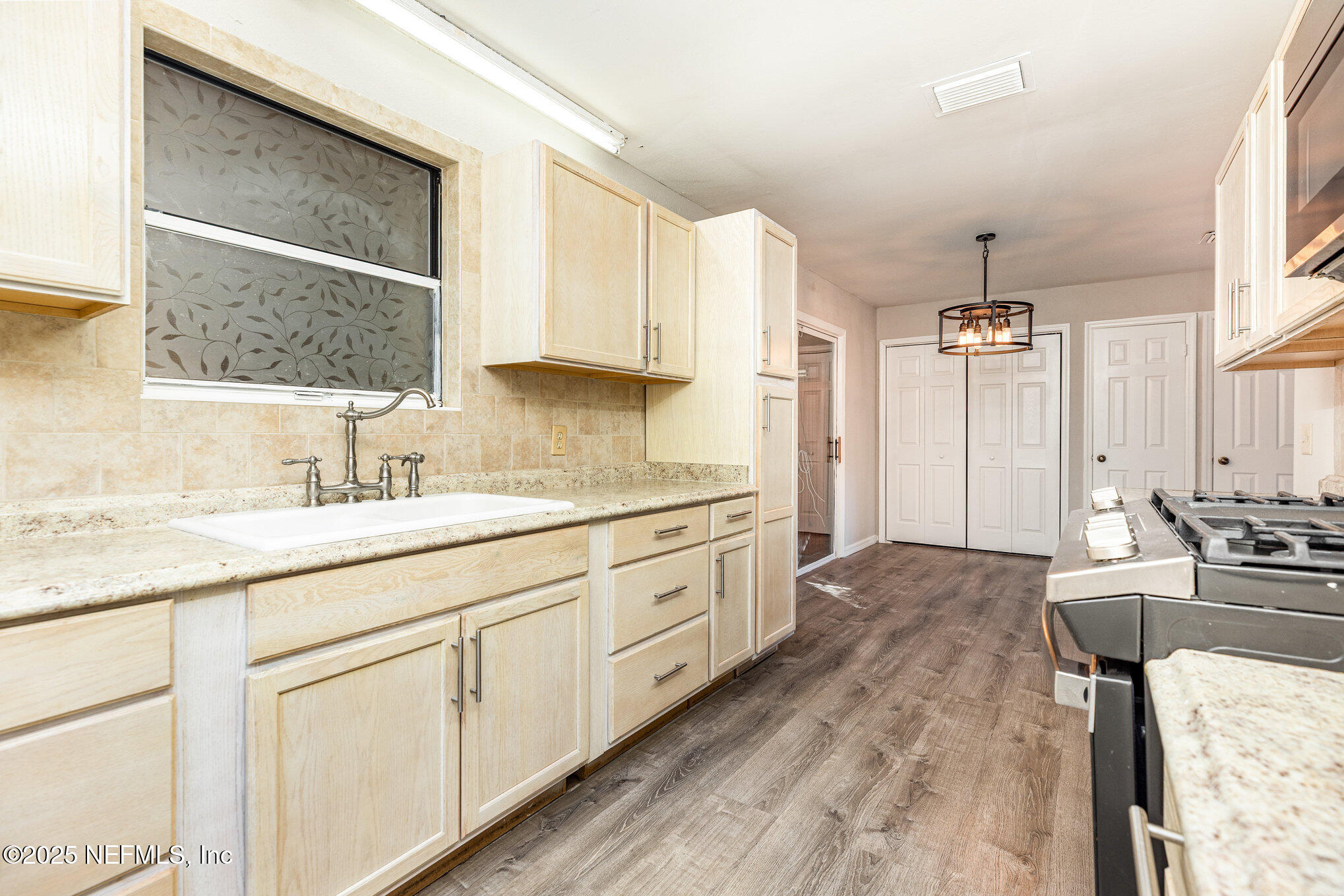 4341 Chokeberry Road Middleburg, FL 32068 - Photo 18 of 38 a spacious bathroom with a granite countertop sink mirror and a