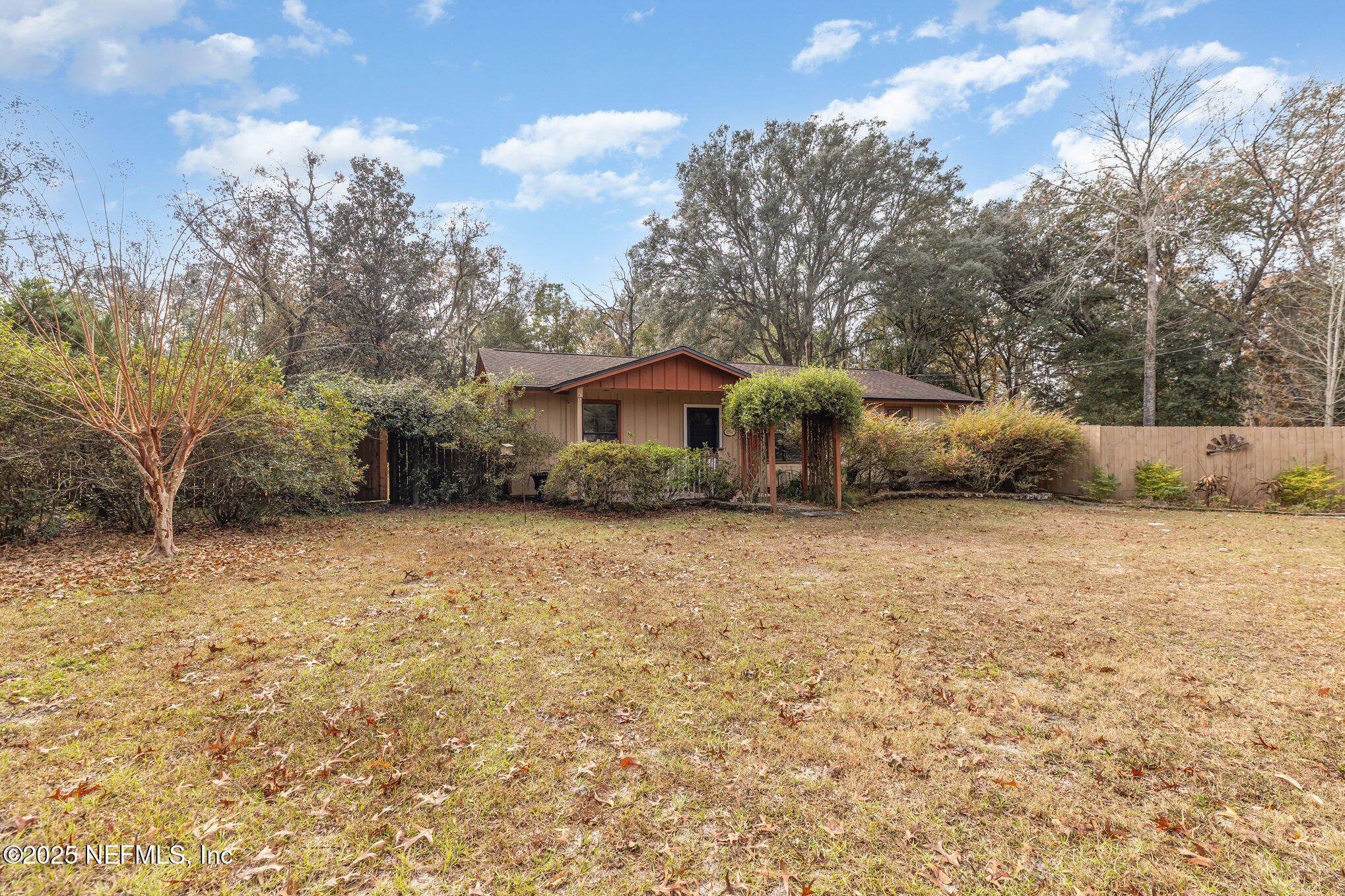 4341 Chokeberry Road Middleburg, FL 32068 - Photo 2 of 38 a front view of a house with a yard and trees