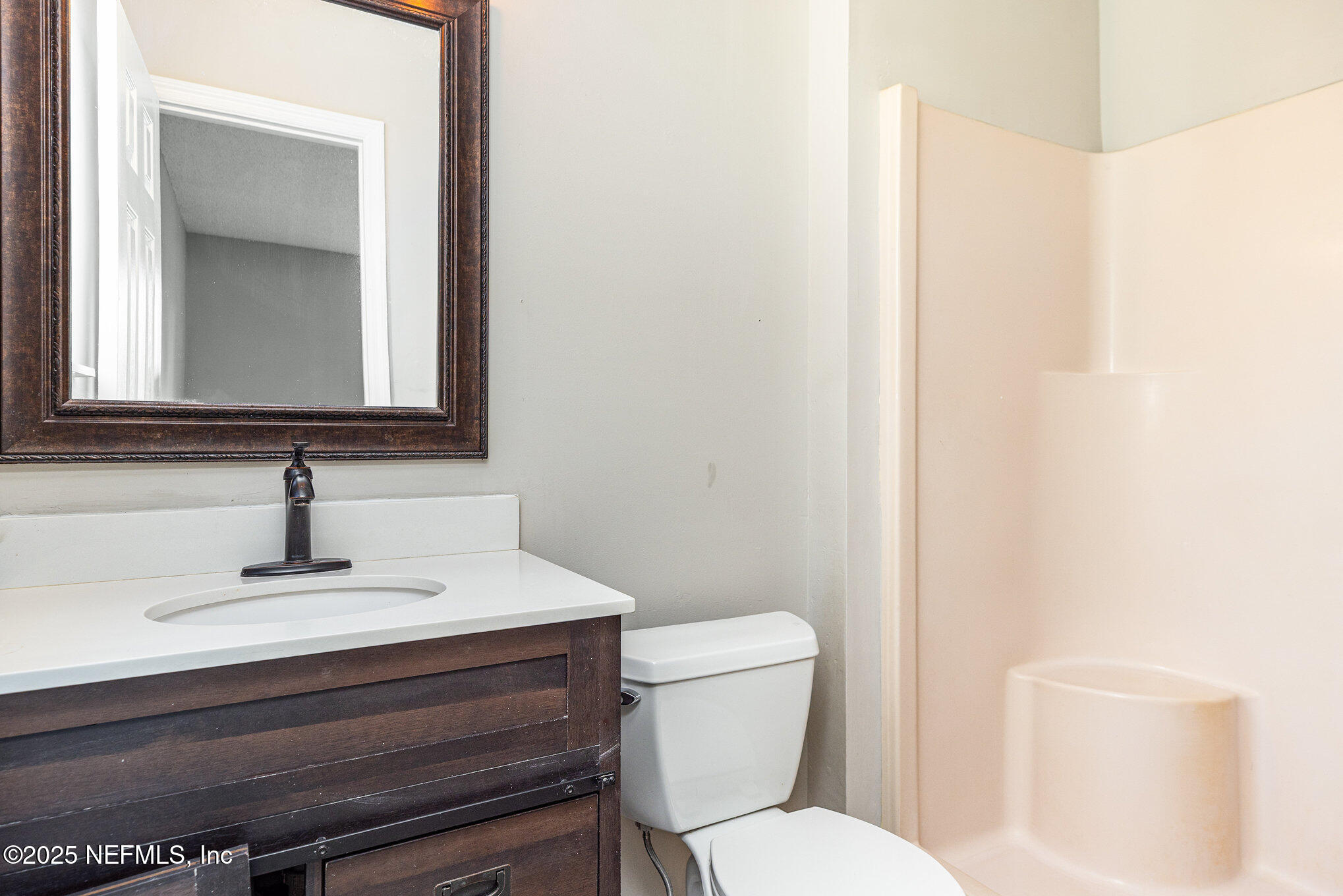 4341 Chokeberry Road Middleburg, FL 32068 - Photo 23 of 38 a bathroom with a toilet a sink and mirror