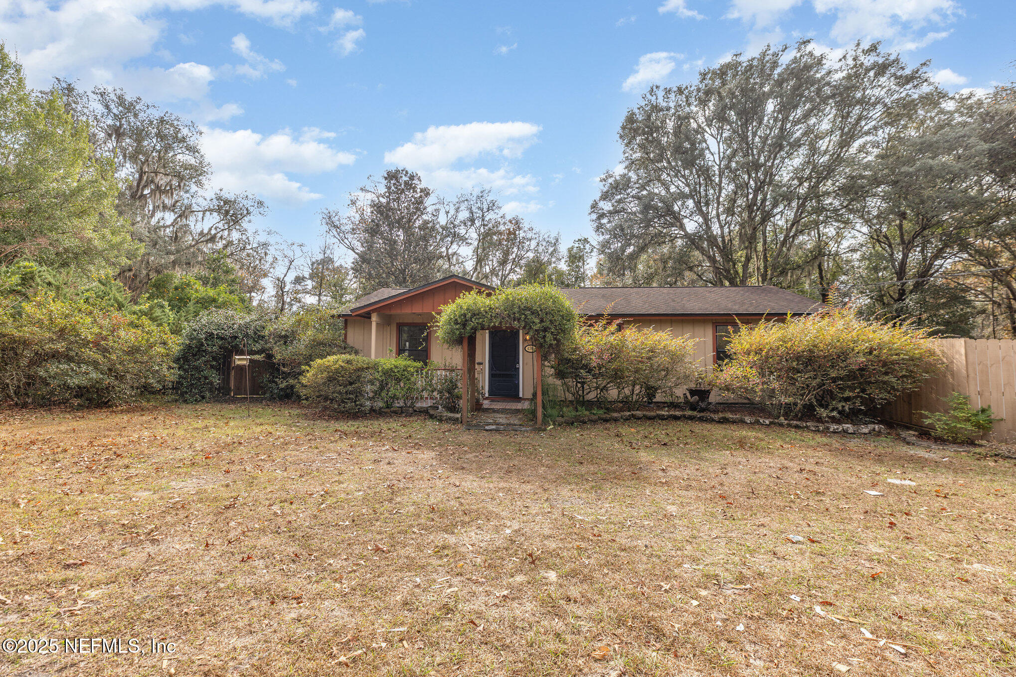4341 Chokeberry Road Middleburg, FL 32068 - Photo 3 of 38 a backyard of a house with table and chairs