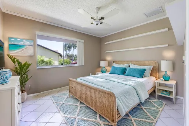 a bedroom with a bed and a potted plant