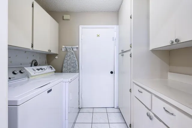 a view of washer and dryer with kitchen in the background