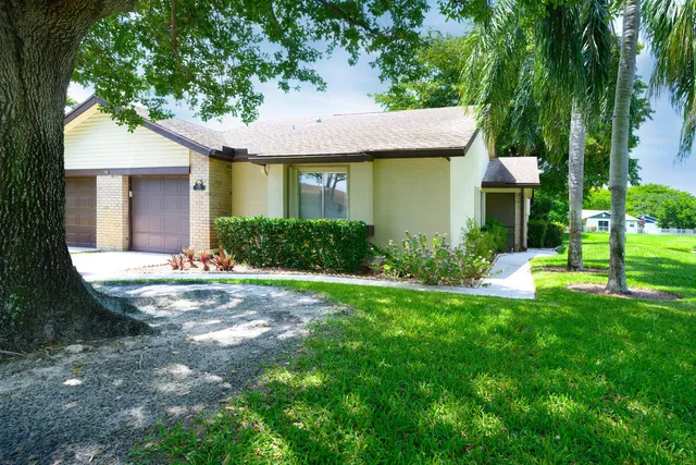 a view of a house with a swimming pool and a yard