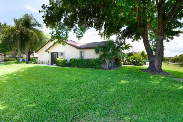 a view of house that has a yard