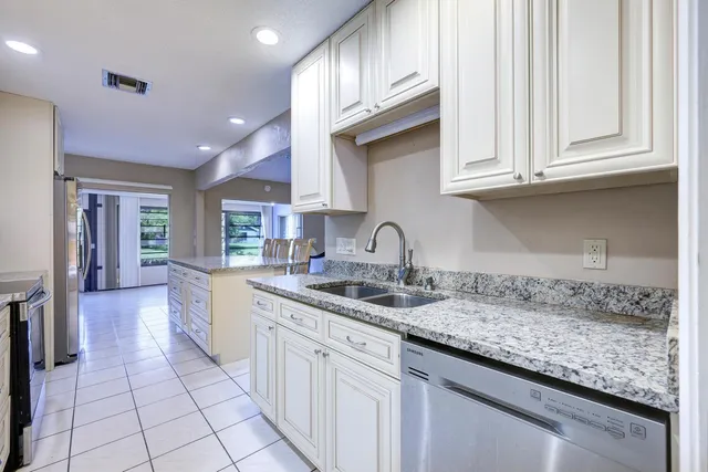 a kitchen with sink cabinets and utility