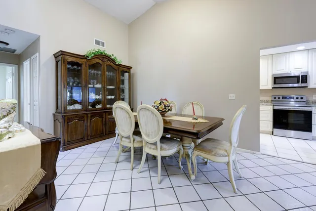 a dining room with furniture and kitchen view
