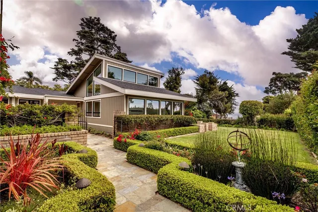 a view of a house with swimming pool and sitting area