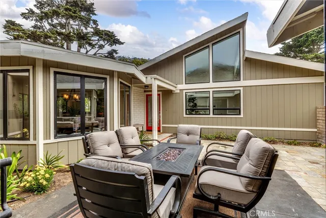 a balcony with furniture and a potted plant