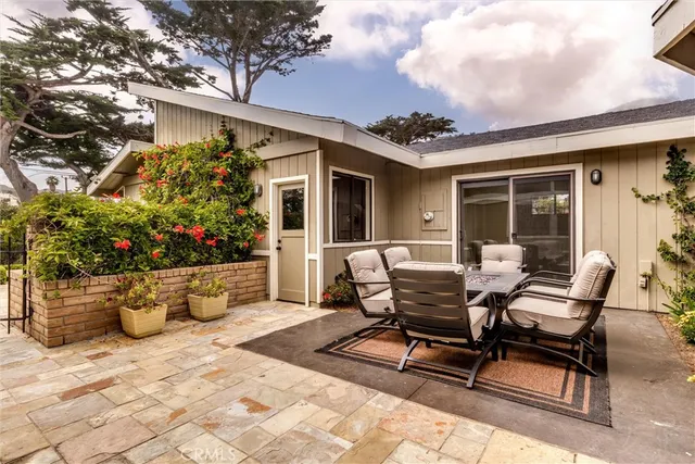 a view of a patio with table and chairs and potted plants