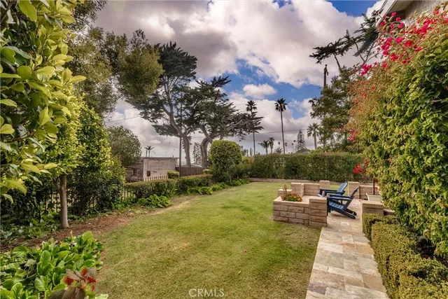 a view of a patio with couches and table and chairs next to yard