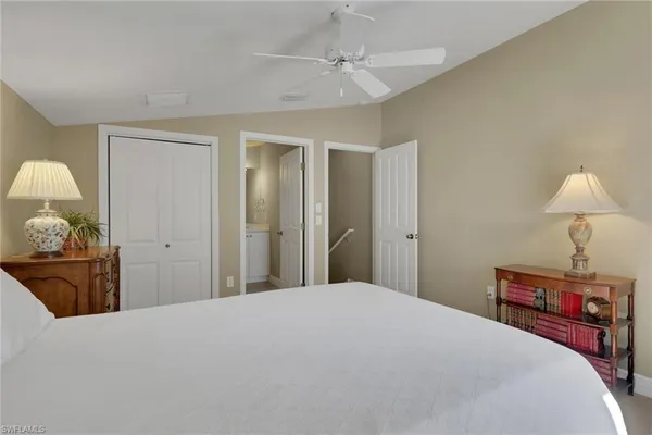a living room with furniture a bed and a lamp