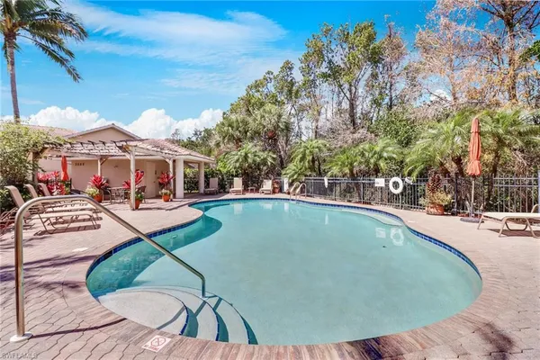 a view of a swimming pool with lounge chairs