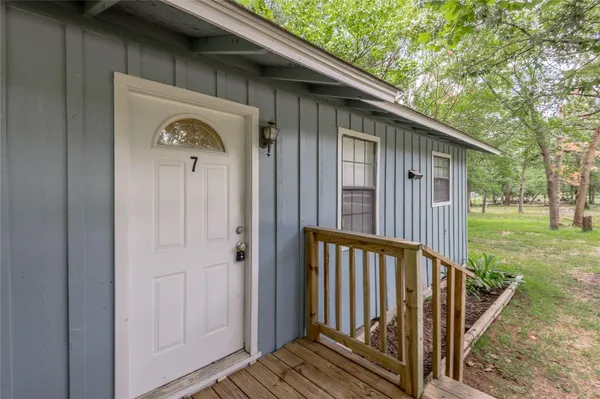 a view of a house with backyard and deck