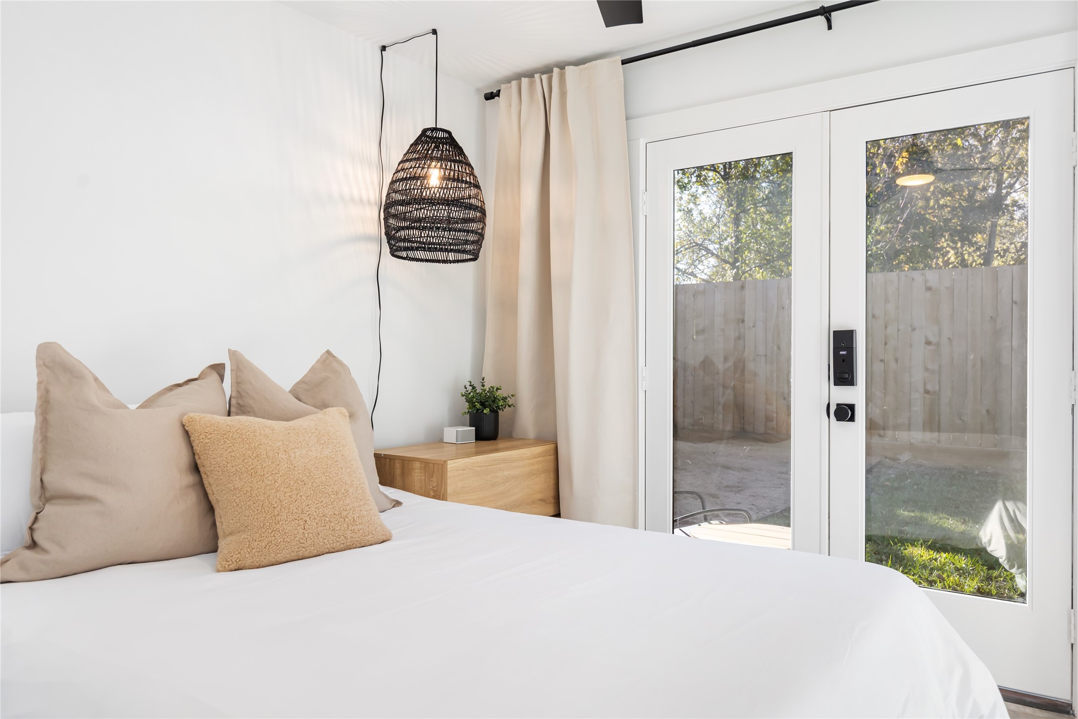 410 East 33rd Street Houston, TX 77018 - Photo 38 of 49 a bedroom with a balcony a bed and a chandelier