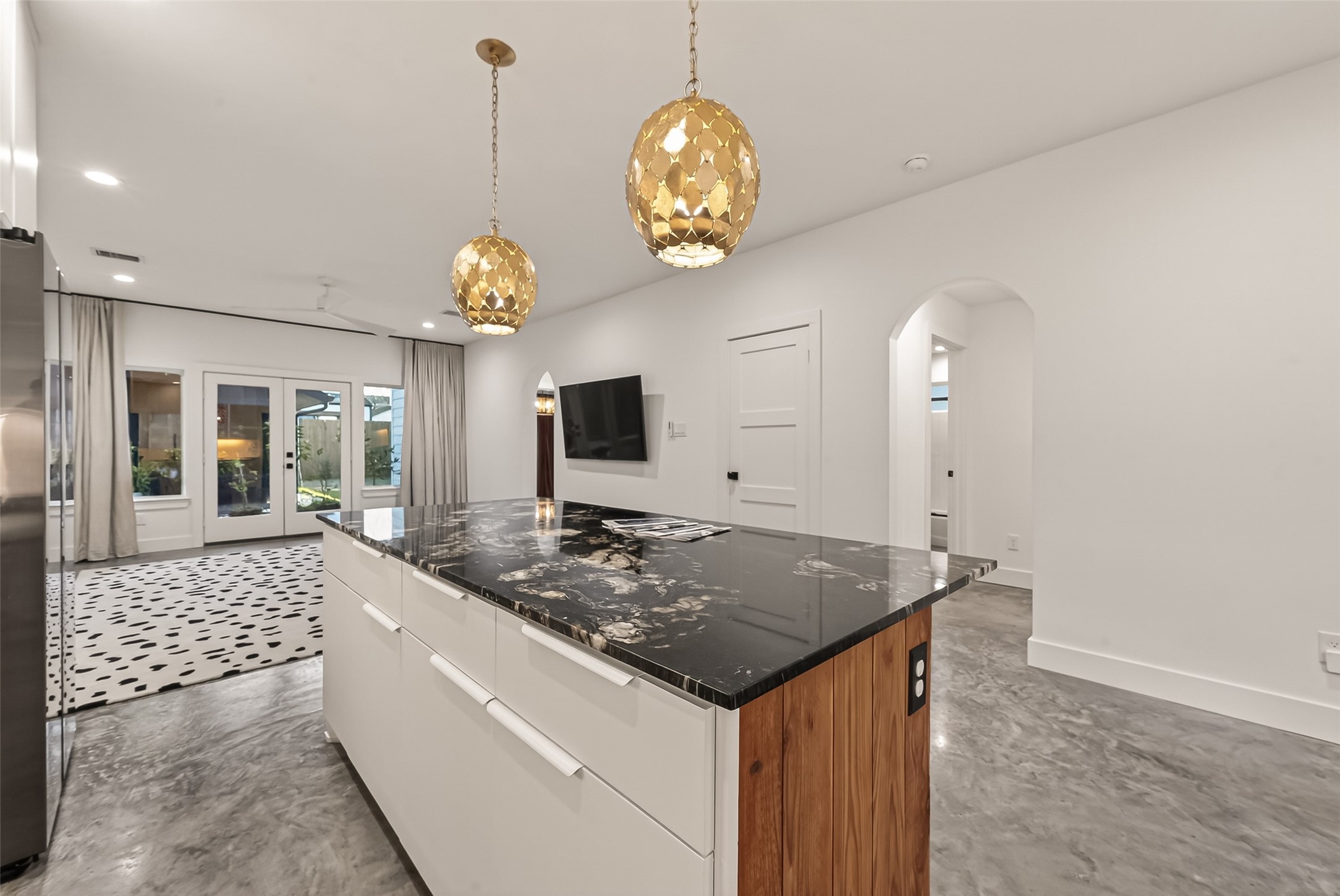 410 East 33rd Street Houston, TX 77018 - Photo 9 of 49 a view of a kitchen island with furniture and chandelier