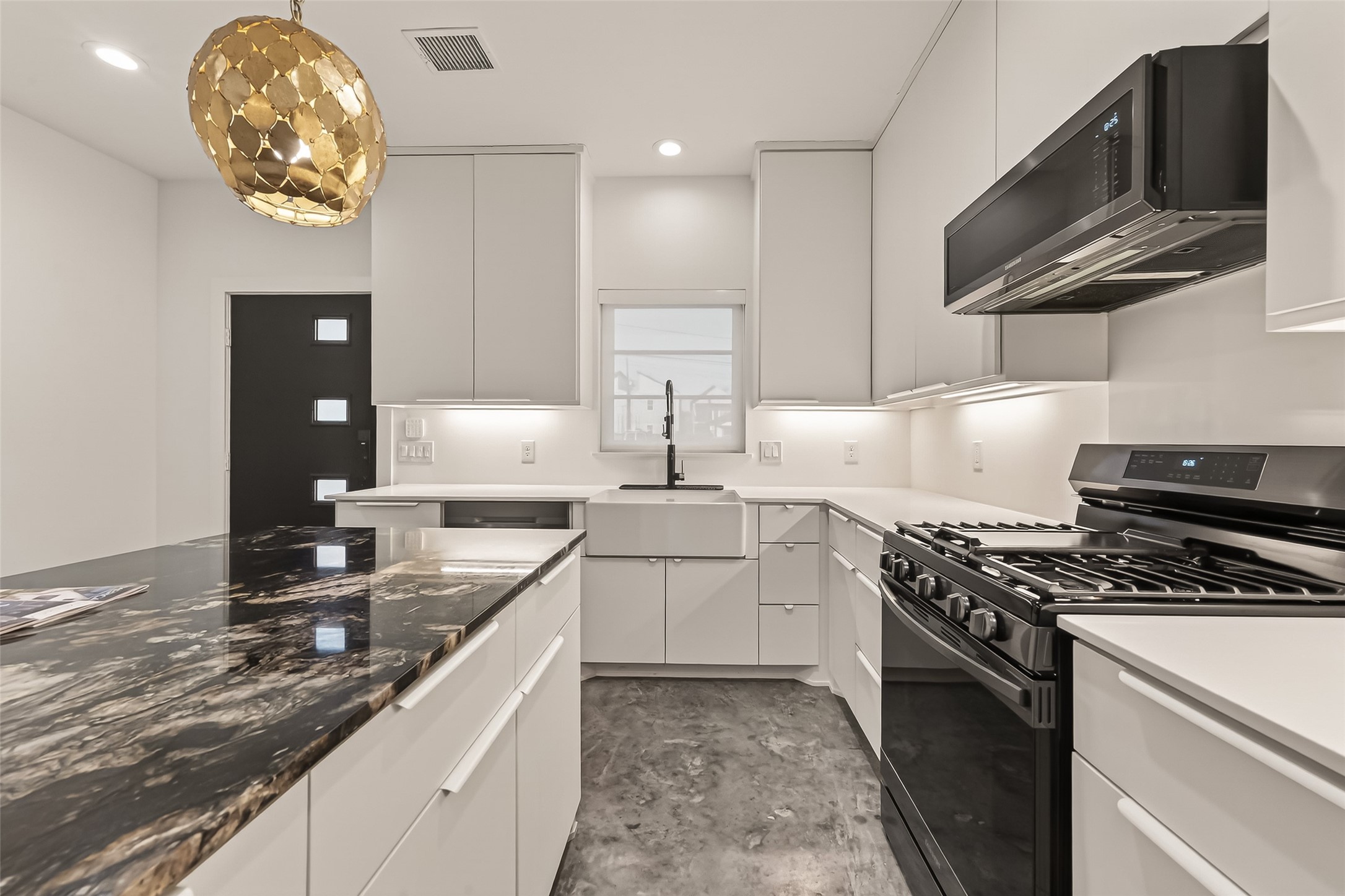 410 East 33rd Street Houston, TX 77018 - Photo 10 of 49 a kitchen with stainless steel appliances granite countertop a sink a stove and a microwave