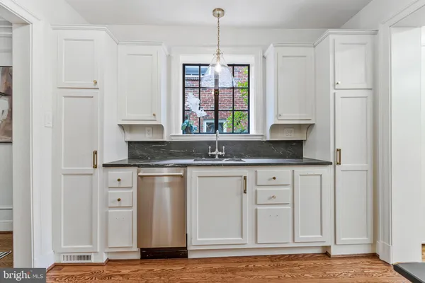 a kitchen with stainless steel appliances granite countertop a kitchen island a stove and a sink