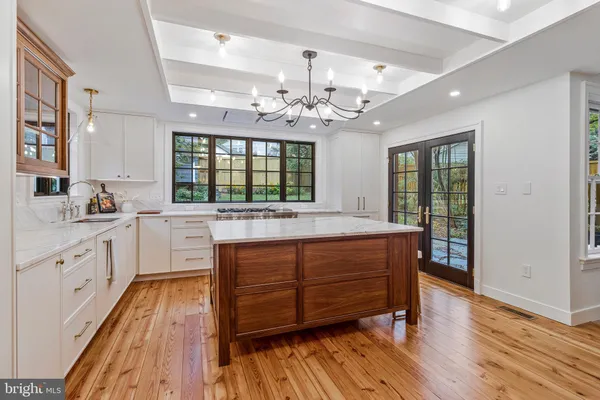 a dining room with furniture and a potted plant