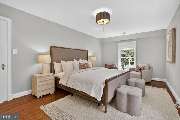 a living room with furniture a chandelier and a window