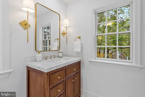 a bathroom with a sink mirror and toilet