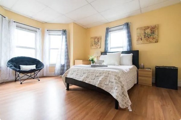 14 Hancock Street Worcester, MA 01610 - Photo 18 of 36 a bedroom with a bed a table and a window