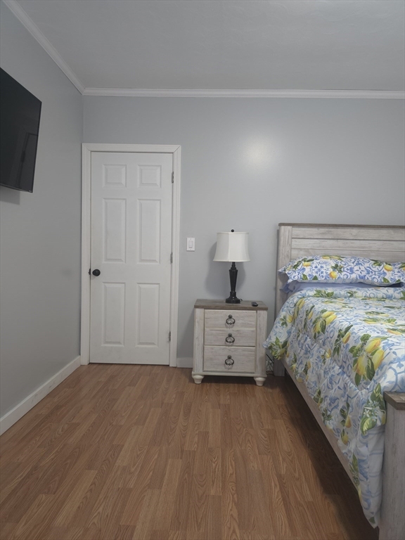 14 Hancock Street Worcester, MA 01610 - Photo 5 of 36 a bedroom with a bed and a flat tv screen on dresser