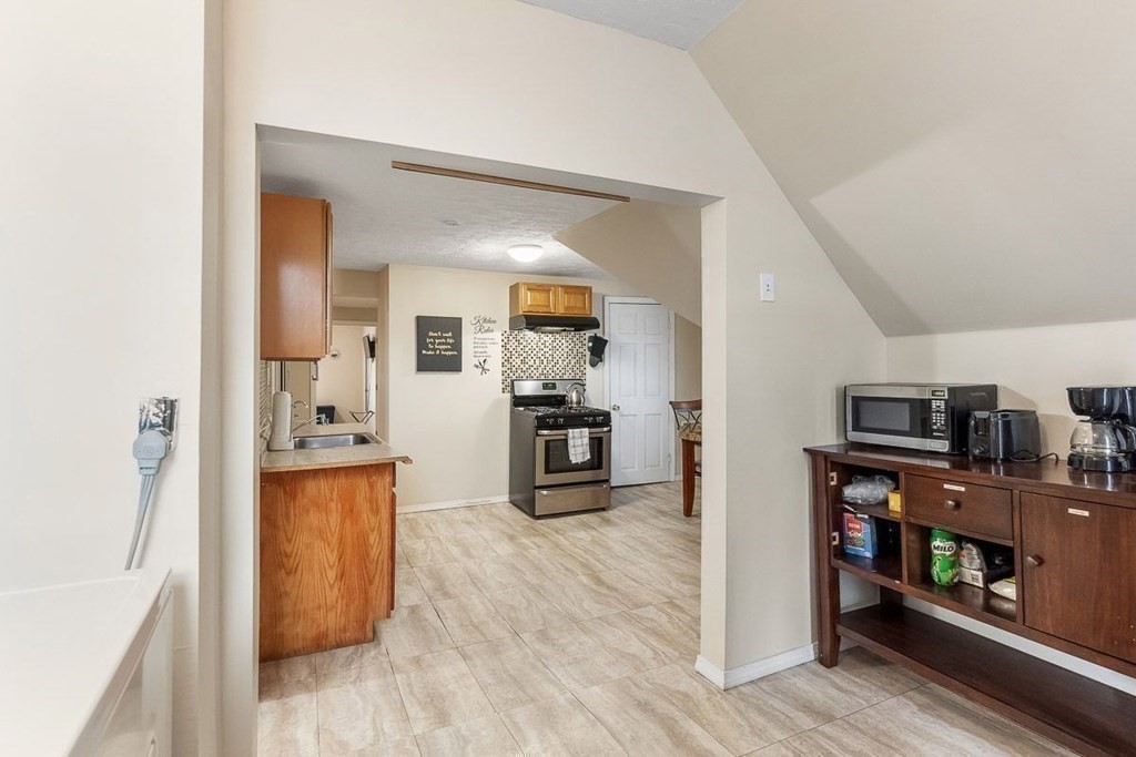 14 Hancock Street Worcester, MA 01610 - Photo 10 of 36 a open kitchen with stainless steel appliances a refrigerator and wooden floor