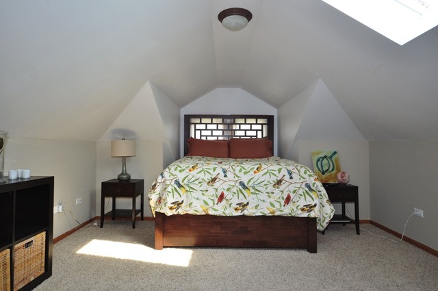 405 Blackhawk Road Riverside, IL 60546 - Photo 11 of 24 a bed sitting in a bedroom next to a window with a chandelier