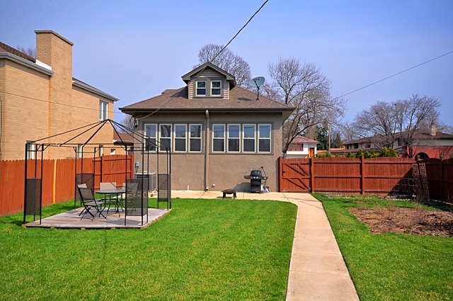 405 Blackhawk Road Riverside, IL 60546 - Photo 17 of 24 a front view of a house with a yard table and chairs