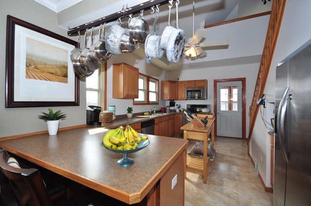 405 Blackhawk Road Riverside, IL 60546 - Photo 6 of 24 a view of a dining room and livingroom with furniture wooden floor a chandelier