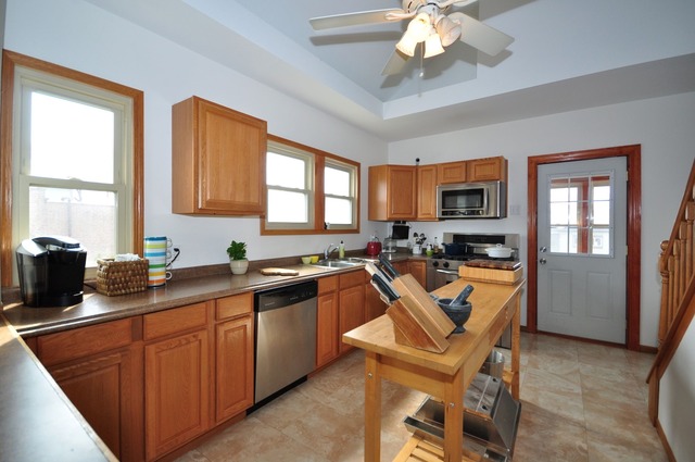 405 Blackhawk Road Riverside, IL 60546 - Photo 8 of 24 a kitchen with stainless steel appliances granite countertop a sink dishwasher stove and refrigerator