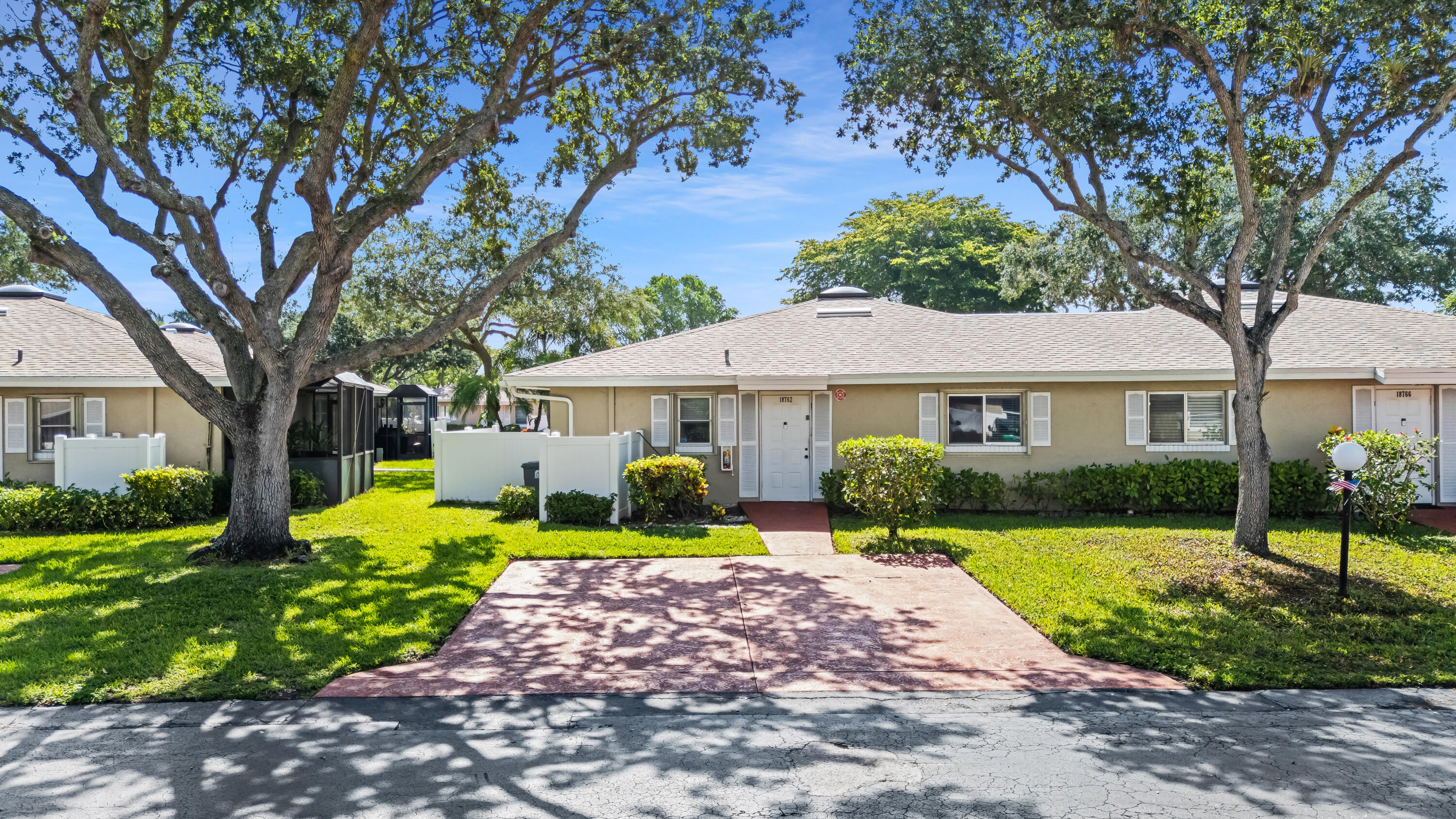 18762 Candlewick Drive Boca Raton, FL 33496 - Photo 3 of 52 a front view of a residential houses with yard and green space