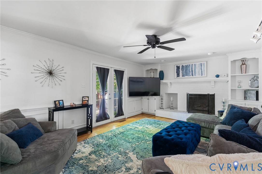 14321 Crossings Ridge Drive Midlothian, VA 23113 - Photo 20 of 43 a living room with furniture a flat screen tv and a fireplace