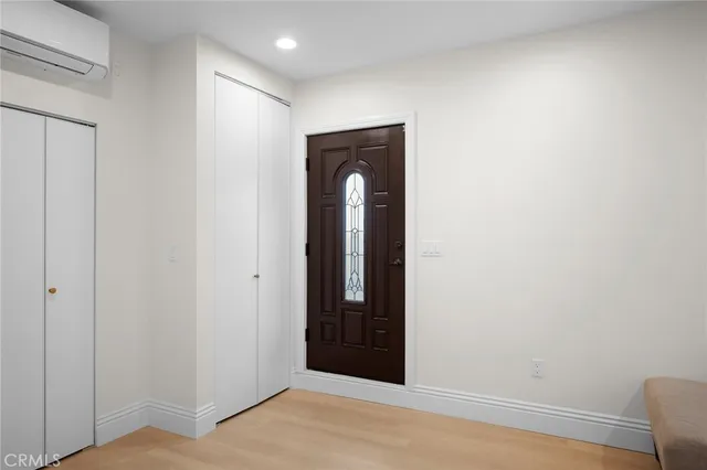a view of a livingroom with wooden floor and a window