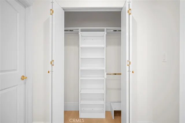 a view of walk in closet with empty racks
