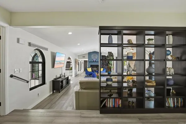 a living room with lots of furniture and a book shelf