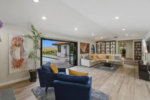a living room with furniture and wooden floor