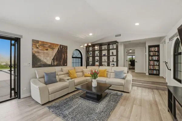 a living room with furniture and a wooden floor