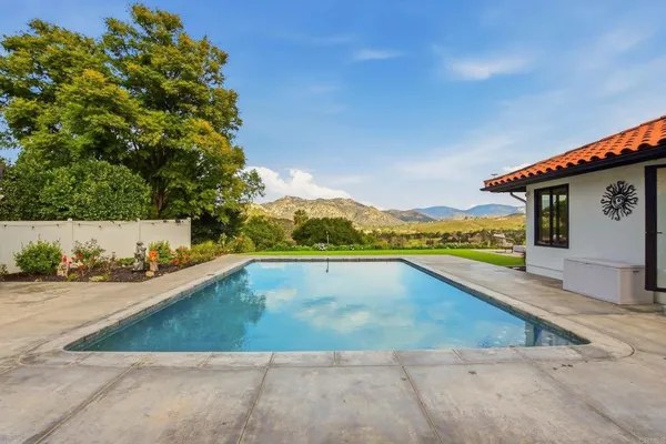 a view of a swimming pool with an outdoor seating