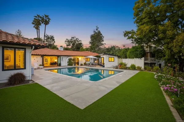 a view of house with swimming pool yard and outdoor seating